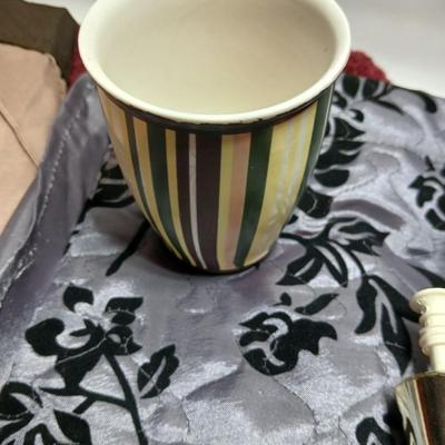 Shower curtains, small rug, and bathroom containers