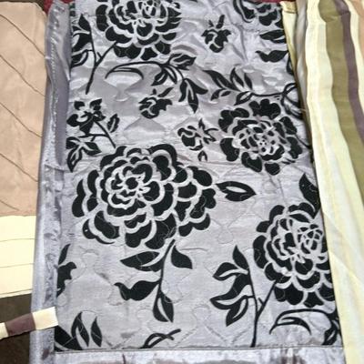 Shower curtains, small rug, and bathroom containers