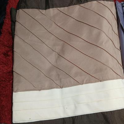 Shower curtains, small rug, and bathroom containers
