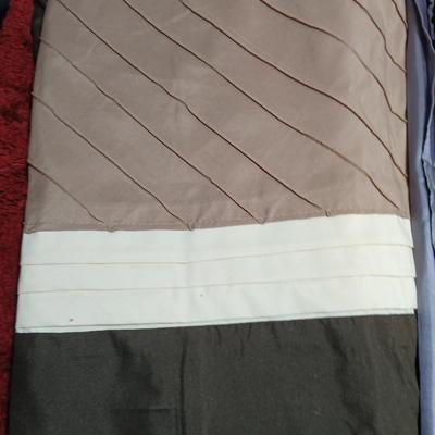 Shower curtains, small rug, and bathroom containers