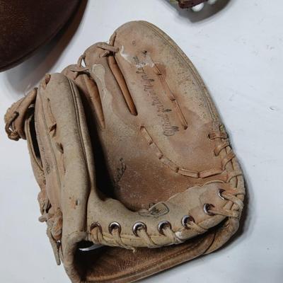 Vintage sporting - Antique metal ice skates, old football and a softball mitt