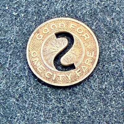 Sale Photo Thumbnail #413: Slightly smaller than a US dime.  Rare, in very good condition. STC began operations in late 1939. This token is most likely a 1940's or 1950's version.