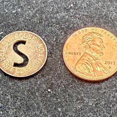 Sale Photo Thumbnail #414: Slightly smaller than a US dime.  Rare, in very good condition. STC began operations in late 1939. This token is most likely a 1940's or 1950's version.