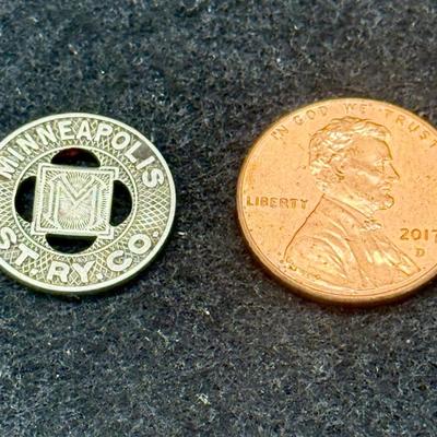 Sale Photo Thumbnail #422: Slightly smaller than a US dime. Rare, in very good condition. Minneapolis Street Railway Company ran from 1873 until about 1950.  This token is likely from the 1940's.