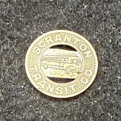 Sale Photo Thumbnail #423: Slightly smaller than a US dime. Rare, in very good condition. The Scranton Transit Company ran from 1934 until about 1972.  This token is likely from the late 1940's or 1950's.