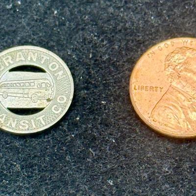 Sale Photo Thumbnail #425: Slightly smaller than a US dime. Rare, in very good condition. The Scranton Transit Company ran from 1934 until about 1972.  This token is likely from the late 1940's or 1950's.