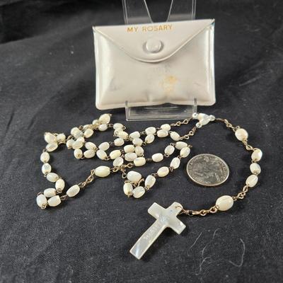 Sale Photo Thumbnail #81: This auction lot is for a Mother of Pearl Beaded Rosary. This is a beautiful Mother of Pearl Beaded Rosary that comes with a white plastic keeping pouch.  The rosary is in very good condition, the pouch shows scuffs.  The word Jerusalem is etched into the