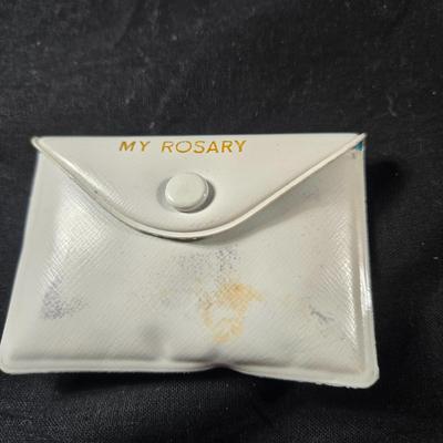 Sale Photo Thumbnail #82: This auction lot is for a Mother of Pearl Beaded Rosary. This is a beautiful Mother of Pearl Beaded Rosary that comes with a white plastic keeping pouch.  The rosary is in very good condition, the pouch shows scuffs.  The word Jerusalem is etched into the