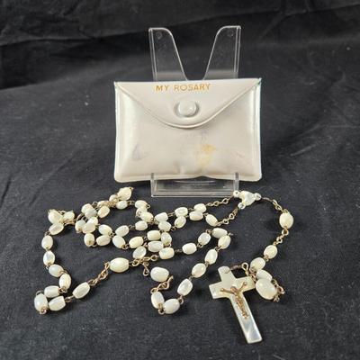 Sale Photo Thumbnail #80: This auction lot is for a Mother of Pearl Beaded Rosary. This is a beautiful Mother of Pearl Beaded Rosary that comes with a white plastic keeping pouch.  The rosary is in very good condition, the pouch shows scuffs.  The word Jerusalem is etched into the