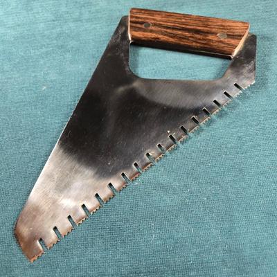 Sale Photo Thumbnail #121: This auction lot is for a very unique Chef's Bread Knife Saw.  The wood handle and stainless steel blade are in very good condition and it is sharp. It is stamped Japan.   It measures about 10.5-inches long and 5-inches wide.  Perfect for the handyman who