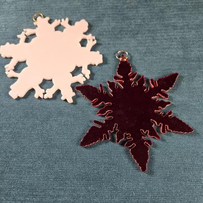 Sale Photo Thumbnail #127: This auction lot is for a Pair of Stained Glass Snowflakes. This is a beautiful Pair of Stained Glass Snowflakes.  They are hand-cut by a glass artist for the holidays.  The dark one is a great deep red and the white one has edges that are snowmen.  Both 