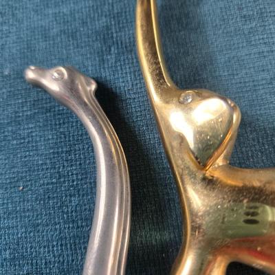 Sale Photo Thumbnail #131: This auction lot is for a pair of Animal Ring Holders. This is a fun and handsome pair of Ring Holder Animals.  The Giraffe is stainless and the Elephant is brass.  They both have faux diamond eyes for bling.  Smart and stylish way of keeping your rings s