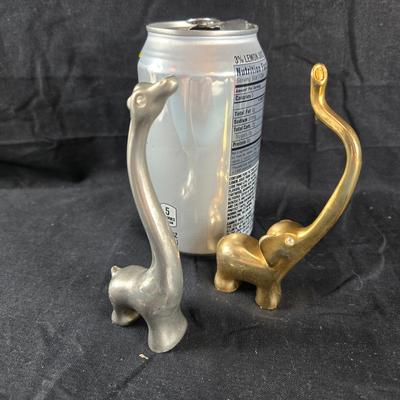 Sale Photo Thumbnail #132: This auction lot is for a pair of Animal Ring Holders. This is a fun and handsome pair of Ring Holder Animals.  The Giraffe is stainless and the Elephant is brass.  They both have faux diamond eyes for bling.  Smart and stylish way of keeping your rings s