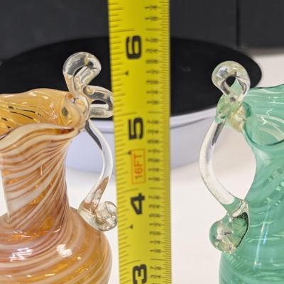 Sale Photo Thumbnail #991: The green vase has a shape edge on the top of the handle.  It is not chipped appears to be made that way
