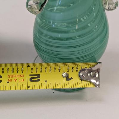 Sale Photo Thumbnail #992: The green vase has a shape edge on the top of the handle.  It is not chipped appears to be made that way