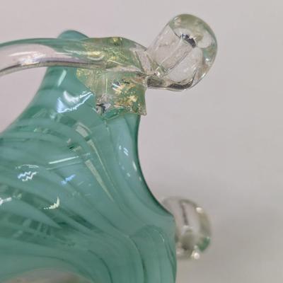 Sale Photo Thumbnail #990: The green vase has a shape edge on the top of the handle.  It is not chipped appears to be made that way