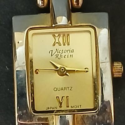 Two gold tone necklaces a pair of earrings and a vintage Victoria Rhein quartz watch