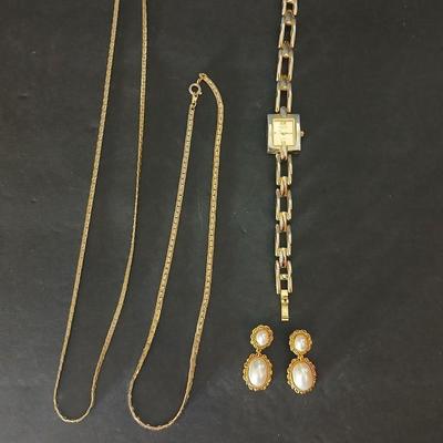 Two gold tone necklaces a pair of earrings and a vintage Victoria Rhein quartz watch