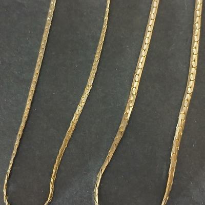 Two gold tone necklaces a pair of earrings and a vintage Victoria Rhein quartz watch