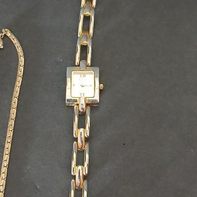 Two gold tone necklaces a pair of earrings and a vintage Victoria Rhein quartz watch