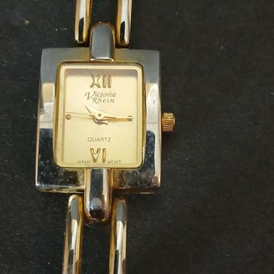 Two gold tone necklaces a pair of earrings and a vintage Victoria Rhein quartz watch
