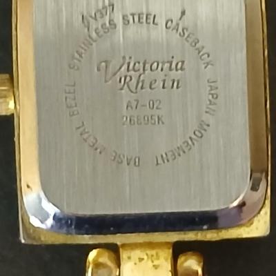 Two gold tone necklaces a pair of earrings and a vintage Victoria Rhein quartz watch