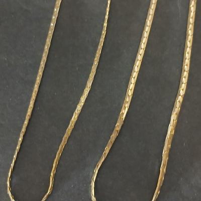 Two gold tone necklaces a pair of earrings and a vintage Victoria Rhein quartz watch