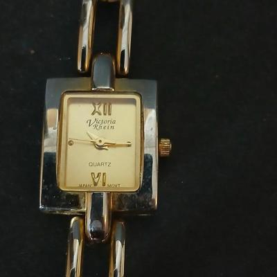 Two gold tone necklaces a pair of earrings and a vintage Victoria Rhein quartz watch