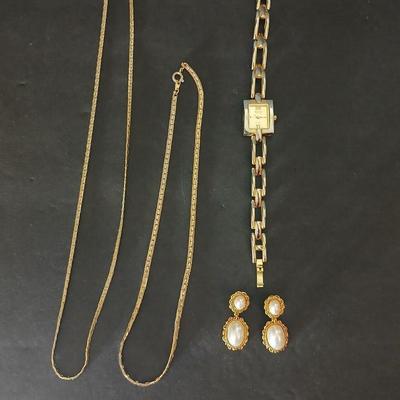 Two gold tone necklaces a pair of earrings and a vintage Victoria Rhein quartz watch