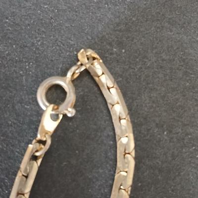 Two gold tone necklaces a pair of earrings and a vintage Victoria Rhein quartz watch