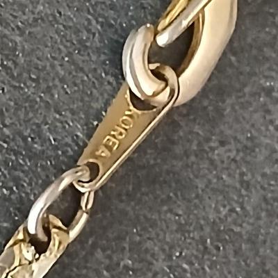 Two gold tone necklaces a pair of earrings and a vintage Victoria Rhein quartz watch