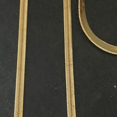 Two thick herringbone gold toned necklaces with two vintage watches one with gold electroplate Bulova band