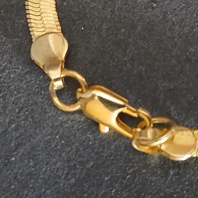 Two thick herringbone gold toned necklaces with two vintage watches one with gold electroplate Bulova band