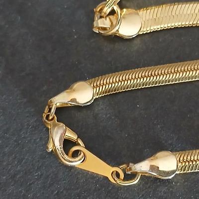 Two thick herringbone gold toned necklaces with two vintage watches one with gold electroplate Bulova band