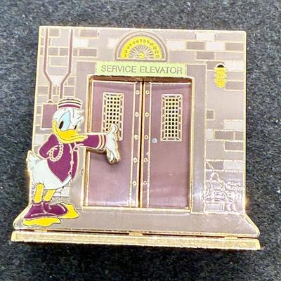 Sale Photo Thumbnail #17: Pin in very good condition. This Disney trading pin features Donald Duck, Mickey Mouse, and Minnie Mouse in a scene inspired by The Twilight Zone Tower of Terror attraction. 
The pin is a diorama-style pin, with Donald dressed as a bellhop leading Mickey 