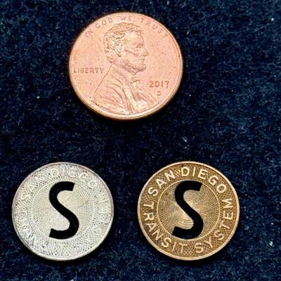 Sale Photo Thumbnail #436: Pair of transit tokens one looks to be made from copper and the other a white metal. Slightly smaller than a US dime. Rare, in very good condition. The San Diego Transit System ran from 1948 until 1967, using a mix of streetcars and busses which were full