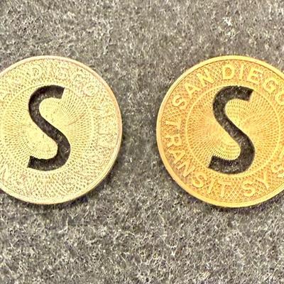 Sale Photo Thumbnail #435: Pair of transit tokens one looks to be made from copper and the other a white metal. Slightly smaller than a US dime. Rare, in very good condition. The San Diego Transit System ran from 1948 until 1967, using a mix of streetcars and busses which were full