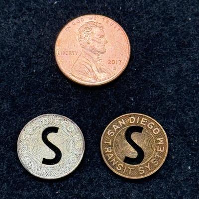 Sale Photo Thumbnail #437: Pair of transit tokens one looks to be made from copper and the other a white metal. Slightly smaller than a US dime. Rare, in very good condition. The San Diego Transit System ran from 1948 until 1967, using a mix of streetcars and busses which were full