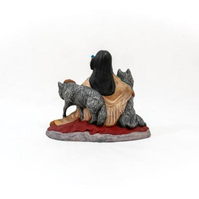 Native American- sculpture featuring a woman sitting with three wolves.