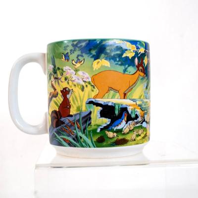Sale Photo Thumbnail #363: Disney store Bambi collectible mug. This mug features scenes from the movie Bambi with characters including Bambi, Thumper the rabbit, Flower the skunk , and the Friend Owl. Its a ceramic mug with a teal-colored interior.