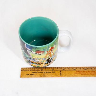 Sale Photo Thumbnail #366: Disney store Bambi collectible mug. This mug features scenes from the movie Bambi with characters including Bambi, Thumper the rabbit, Flower the skunk , and the Friend Owl. Its a ceramic mug with a teal-colored interior.