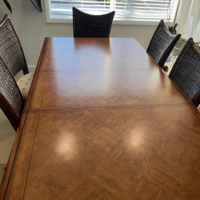 Sale Photo Thumbnail #7: Tommy bahama dinning room table in EXCELLENT condition, always had a cloth on it and seat covers. Comes with seat covers as well to protect the them. No scratches. Has a leaf in it so it can get smaller. 44 inches wide x 92inches long WITH leaf 62 inches 