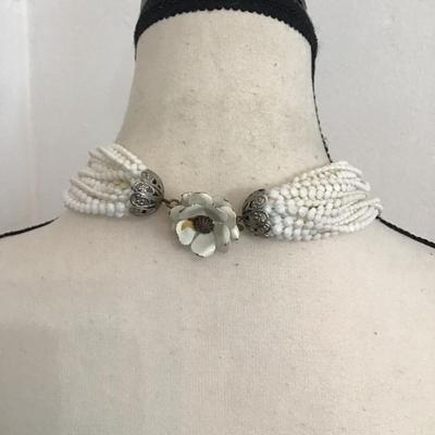 Sale Photo Thumbnail #110: Vintage multi strand, white beaded necklace with floral clasp. Please see attached photos.