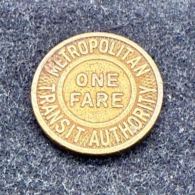 Sale Photo Thumbnail #452: Slightly larger than a US penny. Rare, in very good condition. The Boston MTA ran from 1947 until 1964. This token is likely from the late 1940's or 1950's.