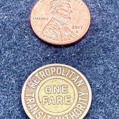 Sale Photo Thumbnail #453: Slightly larger than a US penny. Rare, in very good condition. The Boston MTA ran from 1947 until 1964. This token is likely from the late 1940's or 1950's.