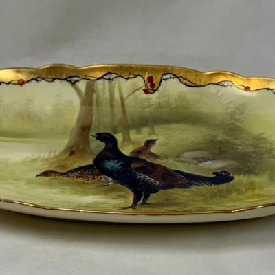 Sale Photo Thumbnail #313: Marked with the Limoges, France decorating firm '"MR France" mark, for Martial Redon, circa 1920's. Signed by the artist. 
This lovely plate features a scalloped rim with a heavy gold border. The center scene is of a male black grouse game bird watching o