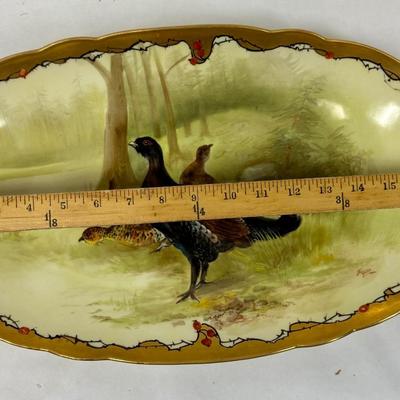 Sale Photo Thumbnail #317: Marked with the Limoges, France decorating firm '"MR France" mark, for Martial Redon, circa 1920's. Signed by the artist. 
This lovely plate features a scalloped rim with a heavy gold border. The center scene is of a male black grouse game bird watching o