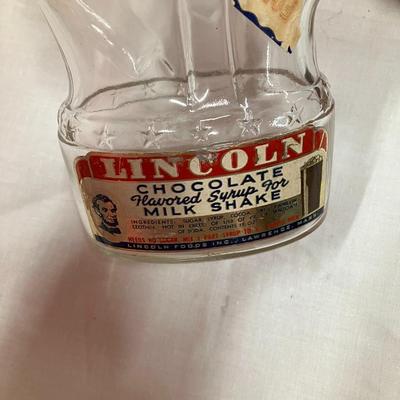 Sale Photo Thumbnail #76: Vintage 1950's Abraham Lincoln glass bank bottle, with chocolate syrup label, approx 8.5" tall