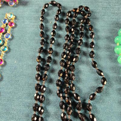 Sale Photo Thumbnail #160: This auction lot is for a Trio of Quality Beaded Necklaces. This is a grouping of 3 quality beaded costume jewelry necklaces. The first one is a multi-colored glass stones encased in sealed polished brass with matching pierced earrings.  It hangs down abo