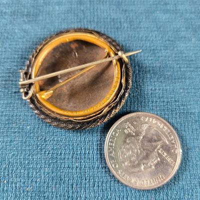 Sale Photo Thumbnail #182: This auction lot is for a Victorian Mourning Broach - #2. This is a Victorian Mourning Broach of an older man.  It is encased in what we think is silver plate that is nicely tarnished with a glass cover.  It is about 1-3/8-inches in diameter.  It is in ve